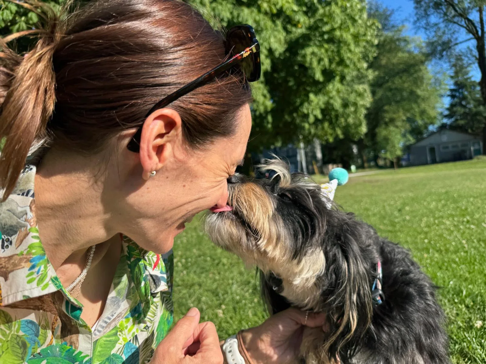 Michelle sharing an affectionate moment with a Dorenlee doodle